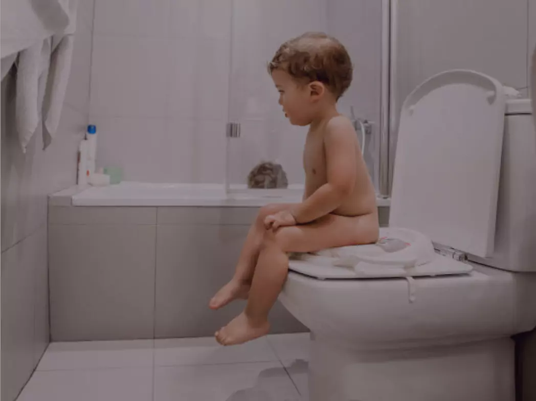Child sitting on the toitlet